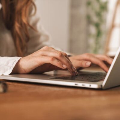 woman typing on a laptop
