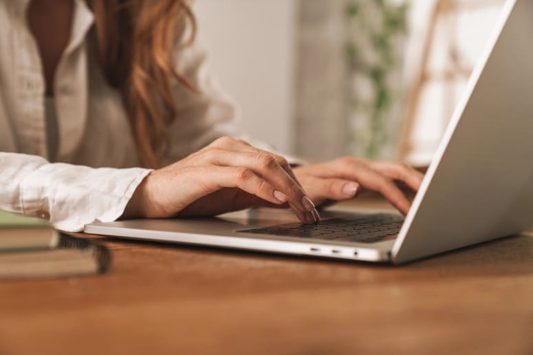 woman typing on a laptop
