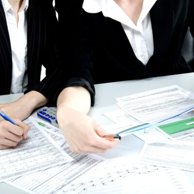 Two people sat at a table looking over documents