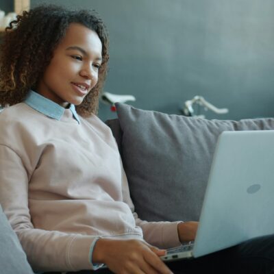 Person on their sofa on their laptop