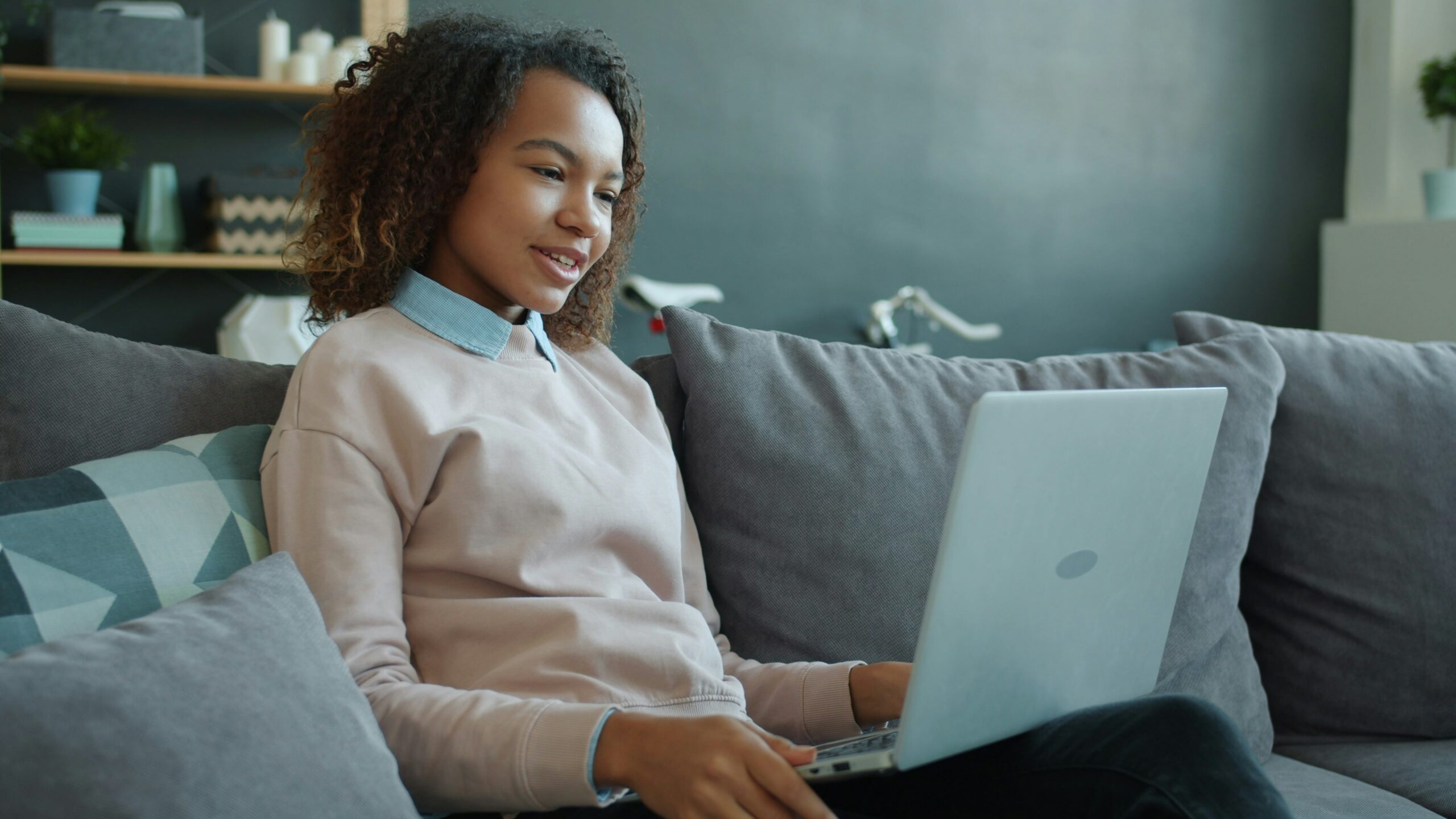 Person sitting on their sofa on their laptop