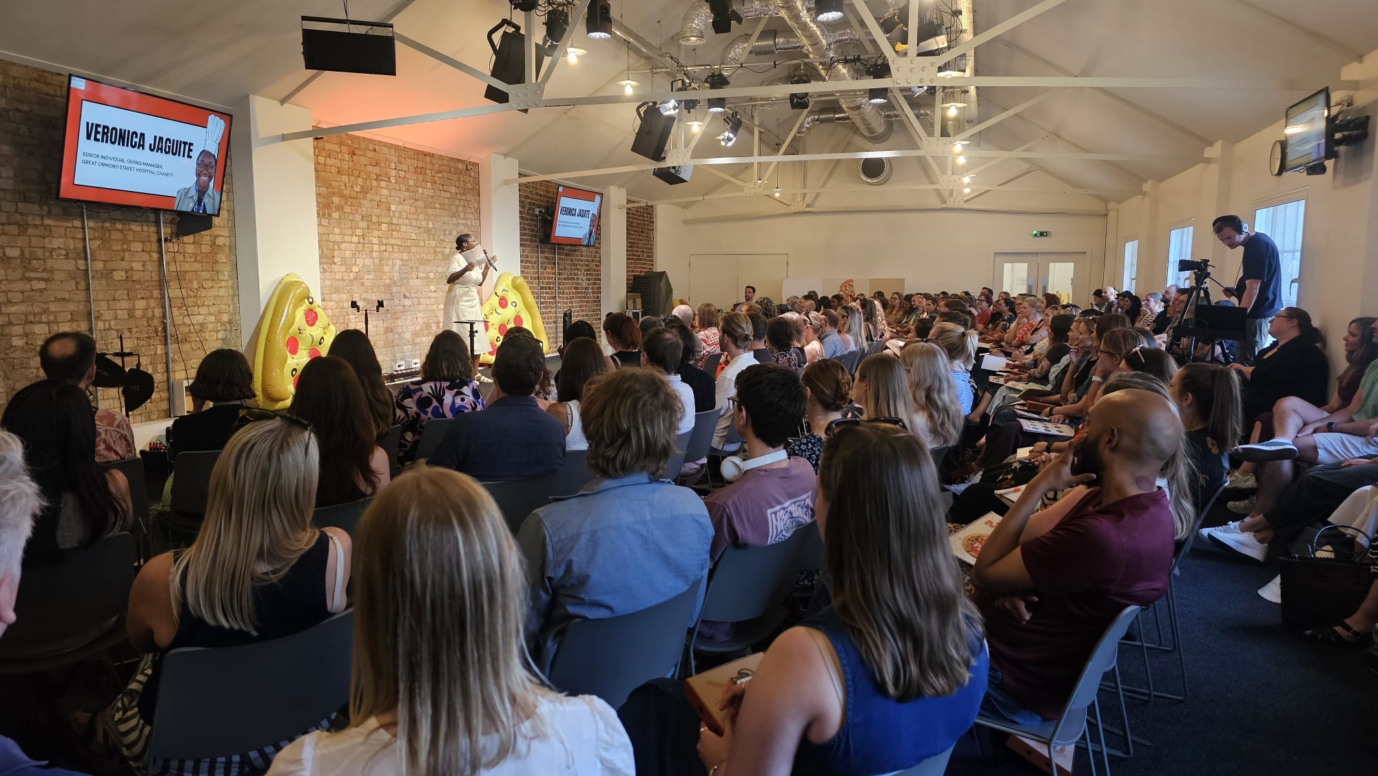 in person 2025 Pizza for Losers crowd shot with speaker on stage